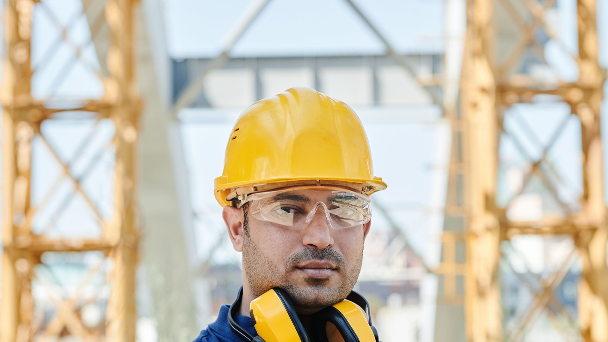 Tradesperson on site holding a clipboard, preparing a quote