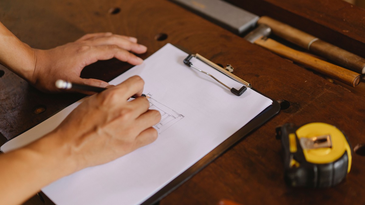 Person taking notes on a clipboard