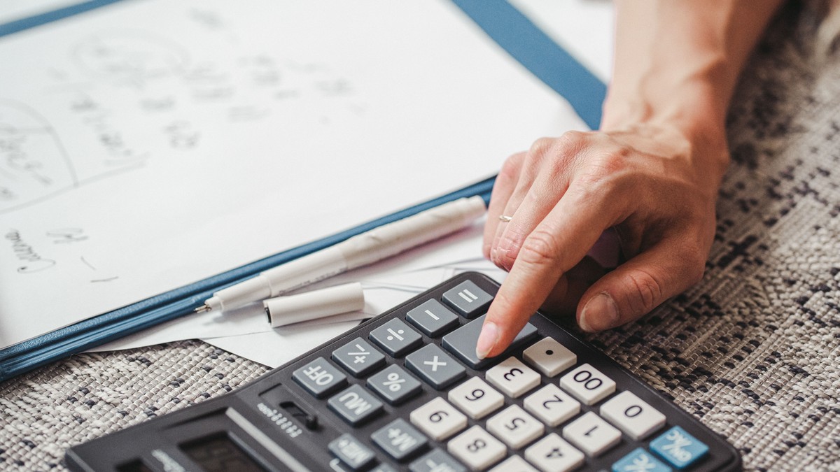 Person using a calculator to work out a quote