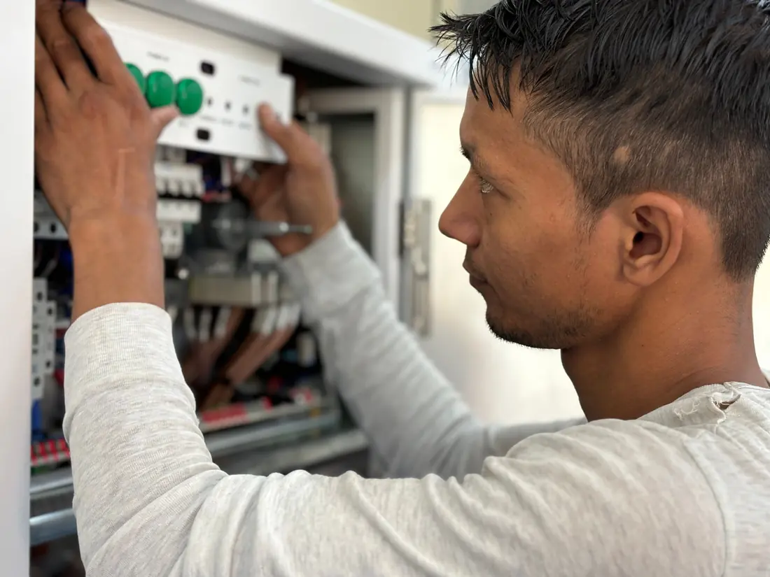 Electrician working on an open switchboard