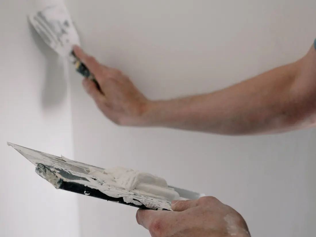 Plasterer stopping a wall joint with a trowel