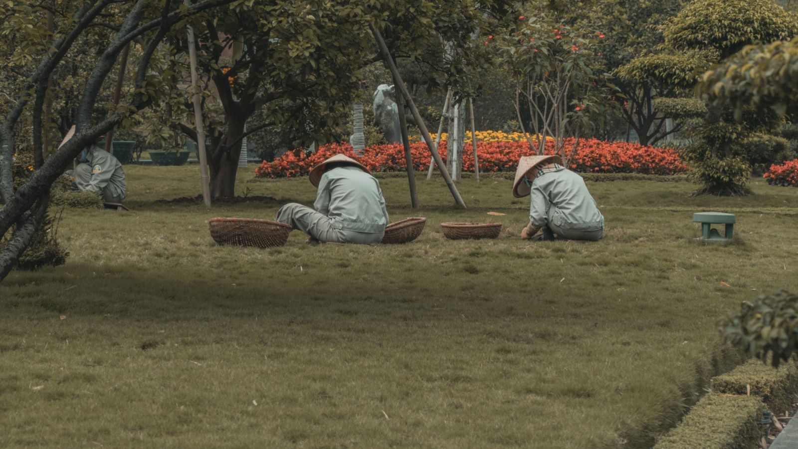 Landscaping crew tending gardens in a lush public park.